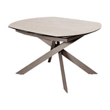 Libra Interiors Extendable Ceramic Stone-Effect Dining Table in warm stone with brushed grey angular intersecting metal legs, on a plain white background.