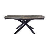 Libra Interiors extendable dining table with smoked grey ceramic stone-effect top and matt black intersecting metal legs, shown on a white background.