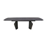 Libra Interiors extendable dining table with a charcoal ceramic stone-effect top, bronze veining, and dark wood-effect pedestal legs on a white background.