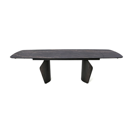 Libra Interiors extendable dining table with a charcoal ceramic stone-effect top, bronze veining, and dark wood-effect pedestal legs on a white background.