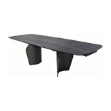 Libra Interiors extendable dining table with charcoal ceramic stone-effect top, bronze veining and curved dark wood-effect pedestal legs on white.
