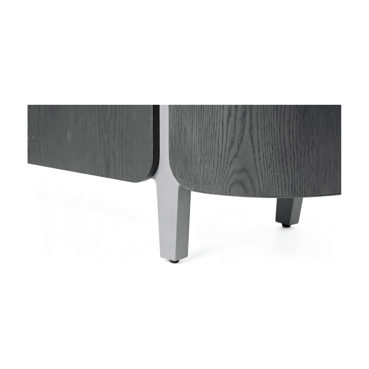Close-up of Libra Interiors Ceramic Top Curved Sideboard in charcoal, showing curved dark oak veneer panels and tapered light grey legs.