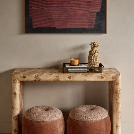 Libra Interiors Burlwood Brass-Detail Console Table in brown, styled in a hallway with abstract art above and two rust boucle stools beneath.
