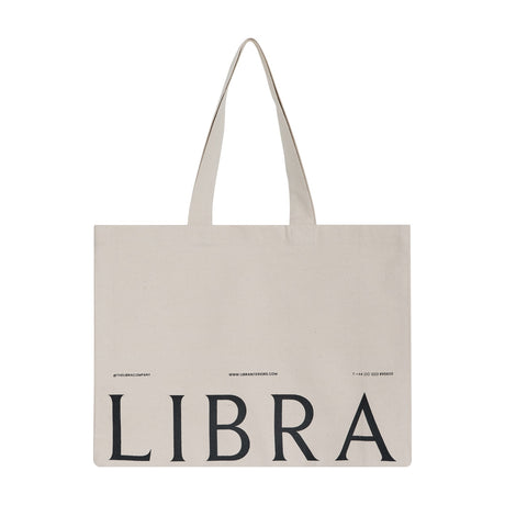 Libra Interiors natural cotton tote bag with long shoulder handles and black LIBRA lettering printed across the front, shown on a plain white background.