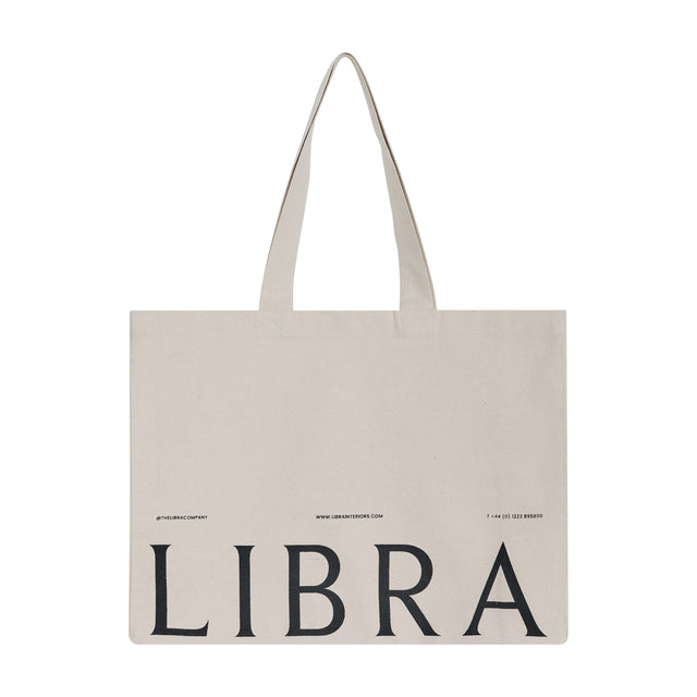 Libra Interiors natural cotton tote bag with long shoulder handles and black LIBRA lettering printed across the front, shown on a plain white background.