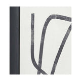 Close-up of a black-framed canvas wall art print showing bold abstract squiggle lines in charcoal grey on an off-white textured background.