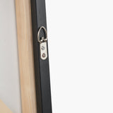 Close-up of the black wooden frame corner on the Gold & Blue Tone Abstract Canvas, showing the D-ring hanging hardware and raw wood canvas edge against a plain white background.