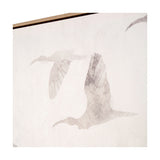 Corner detail of natural canvas wall art in a wood frame, showing muted grey silhouettes of birds in flight against a white background.