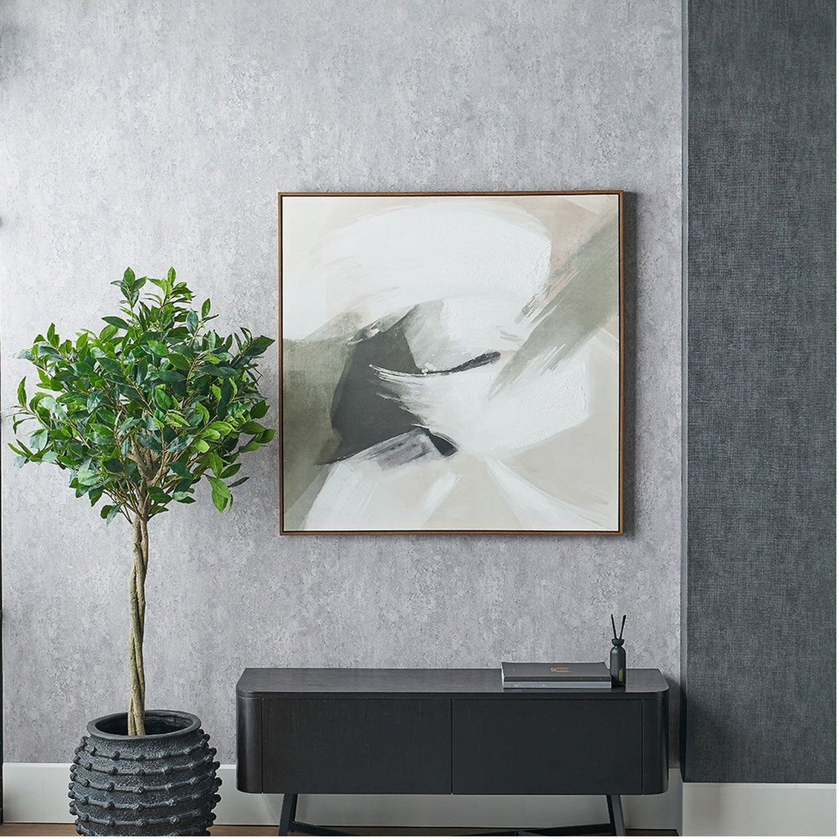 Monochrome Abstract Square Canvas with oak effect frame, 100 x 100cm, hung on a grey textured wall above a black sideboard beside a potted tree.