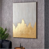 Frameless textured canvas wall art, 100 x 140cm, in white with a gold abstract peak design, shown mounted on a grey wall above a side table and plant.
