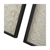 Close-up of two natural paper wall art panels in black frames, one with raised floral discs, the other with a linear square pattern, on a white background.