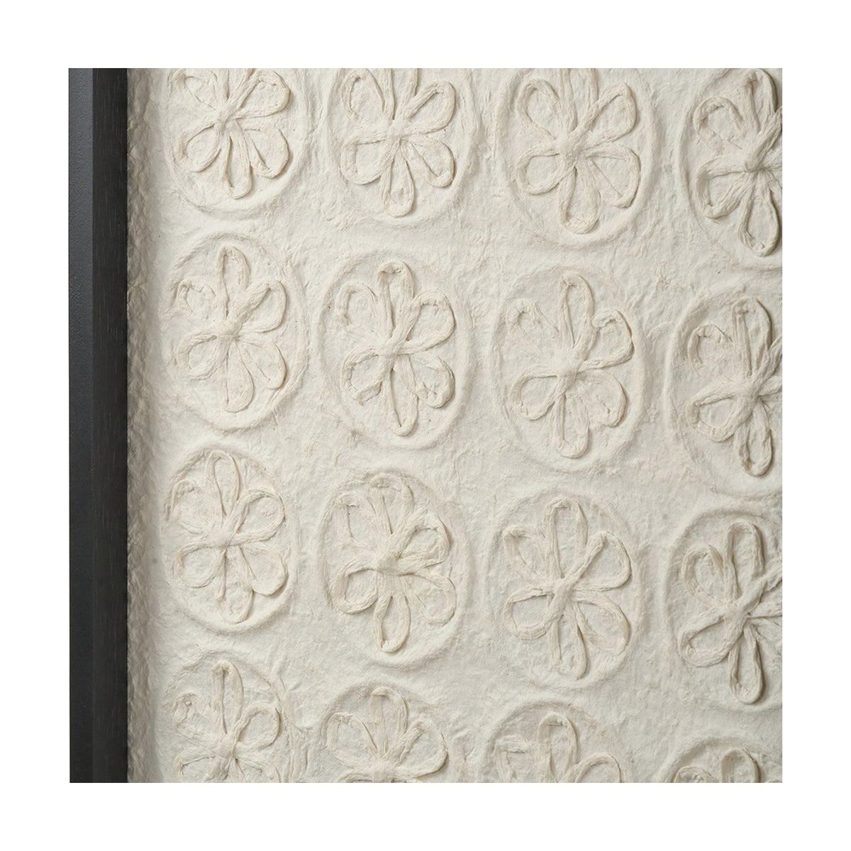 Close-up of Natural Paper Design Wall Art with a black frame, showing raised floral motifs in a repeating grid on textured white handmade paper.