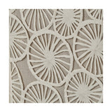 Close-up of natural paper cut-out wall art with layered wheel-shaped spoke patterns in white on a beige linen backing, part of a set of 2 framed pieces.
