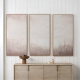 Set of 3 wood-framed canvas wall art panels in natural and white tones, depicting misty grasses and birds, displayed above a wooden sideboard.