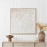 White & Natural Floral Square Canvas, 100 x 100cm, wood-framed wall art with soft leaf pattern, displayed above a wooden sideboard with vase and decor.