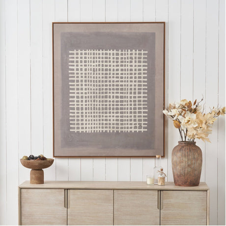 Brown & Natural Grid Design Canvas with Oak Effect Frame, 100 x 120cm, displayed above a light wood sideboard with a vase and decorative accessories.