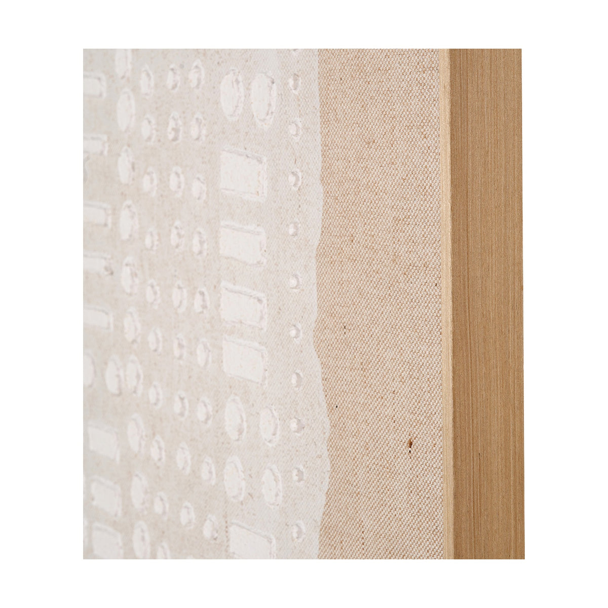 Close-up of textured white abstract wall art on natural linen canvas, showing raised circular and rectangular patterns beside a light elm wood frame edge.