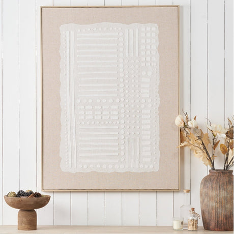 Textured White & Natural Abstract Design Linen Canvas with Elm Frame, featuring raised white geometric patterns on natural linen, displayed on a shiplap wall beside a vase of dried flowers.