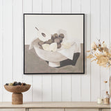 Fruit Design Canvas with Black Frame, 70 x 70cm, depicting a bowl of pears and grapes with draped cloth in earthy neutral tones, shown on a white panelled wall above a sideboard.