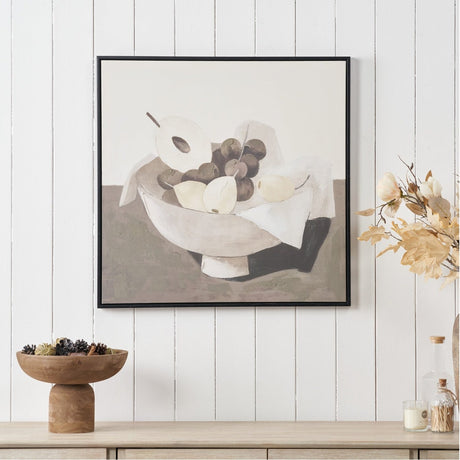 Fruit Design Canvas with Black Frame, 70 x 70cm, depicting a bowl of pears and grapes with draped cloth in earthy neutral tones, shown on a white panelled wall above a sideboard.