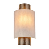 Endon Brenwood wall light with hammered aged bronze metalwork and a natural linen-effect fabric shade, illuminated on a plain white background.