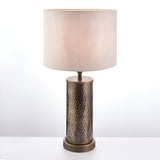 Endon Brenwood table lamp with a hammered aged bronze cylindrical steel base and natural linen-effect drum shade, shown on a plain light background.