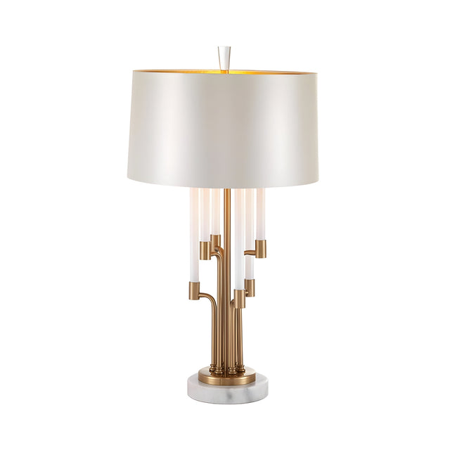 The Calystron 1 Light Branched Alabaster Table Lamp in Brass & Soft White features a modern sculptural design with a white cylindrical shade, gold and clear rods, and a round white marble base, shown on a white background.