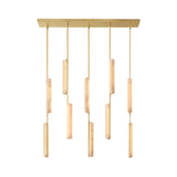 Niori Selvara linear chandelier with ten vertical alabaster batons at staggered drops from a brushed brass rectangular canopy, on a white background.