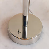 Close-up of the Endon Crandale USB table lamp base in bright nickel plate, showing the toggle switch and slim upright stem on a marble surface.