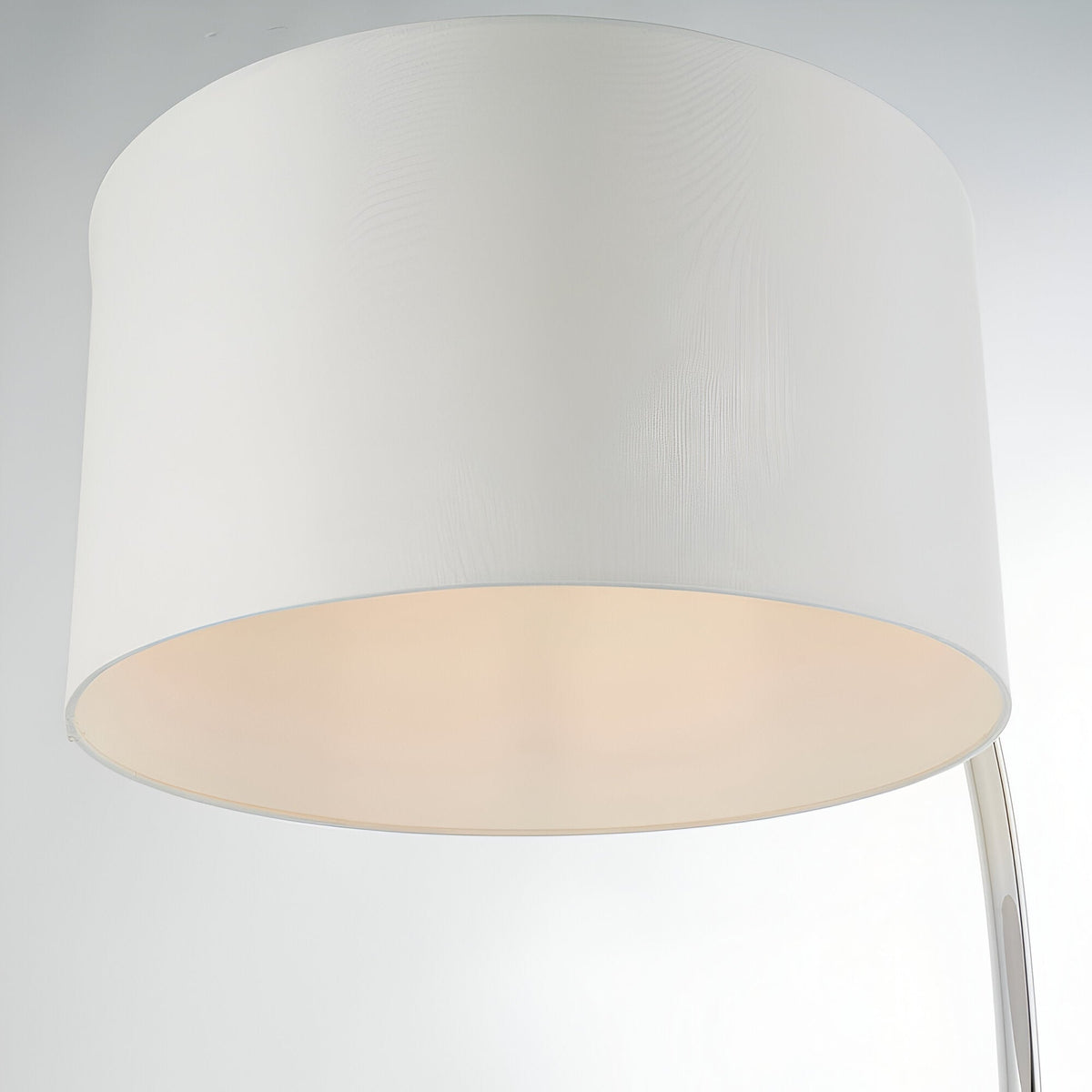 Close-up of the Brockfield Floor Lamp's large drum shade in white faux silk with a polished nickel arm visible, on a plain light background.