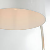 Close-up of the Brockfield Floor Lamp's white faux silk drum shade and curved polished nickel stem, shown against a plain light background.