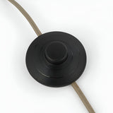 Close-up of the round matte black inline foot switch on the Brockfield Floor Lamp's fabric cable, shown on a white background.