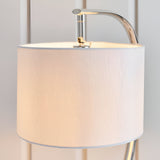 Brockfield Table Lamp in nickel with an arched chrome stem and white faux silk drum shade, close-up view against a plain light background.