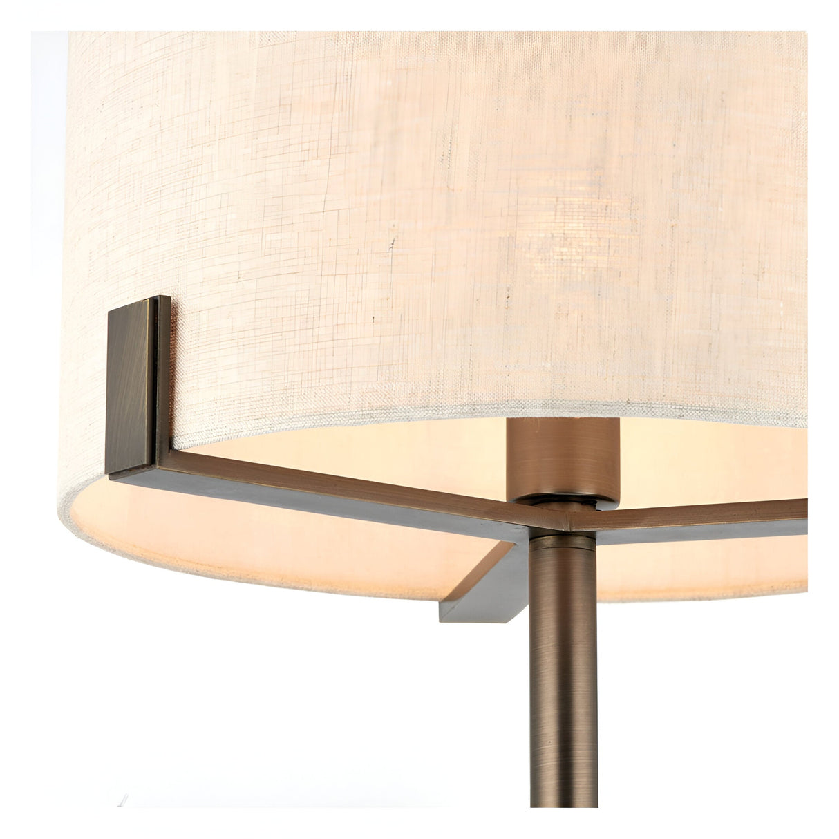 Close-up of the Brendon Table Lamp in bronze finish, showing metal frame supports and stem beneath a natural linen drum shade.