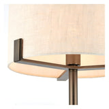 Close-up of the Brendon Table Lamp in bronze finish, showing metal frame supports and stem beneath a natural linen drum shade.