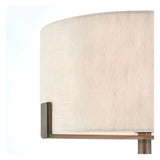 Close-up of the Brendon Table Lamp's natural linen drum shade with bronze bracket detail, set against a plain white background.