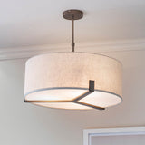 Brendon 3 Light Pendant in bronze, large drum-shaped fabric shade with metal frame, adjustable stem, shown hanging in a room setting.