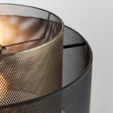Close-up of the Chartfield Pendant in brass and black, showing double perforated mesh cylinder shades with a lit E27 bulb visible inside.