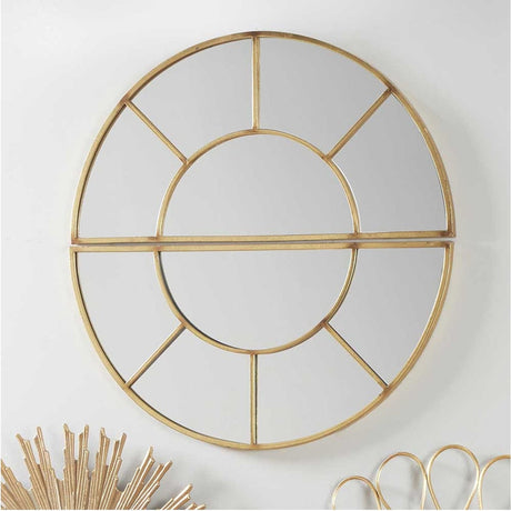 Round wall mirror in antique gold iron with a spoke-style frame divided into two half-moon sections, mounted on a plain white wall.