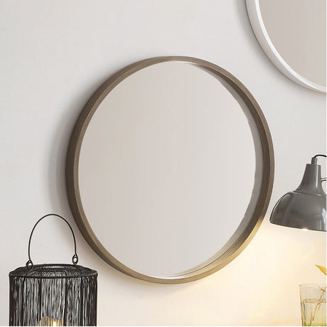 Round wall mirror with slim natural wood veneer frame, 56 x 56cm, shown on a light wall above a lamp and wire lantern in a living room setting.