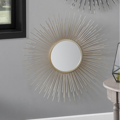 Gold Iron Starburst Design Round Wall Mirror, 80 x 80cm, with radiating metal rods, shown mounted above a side table in a grey hallway setting.