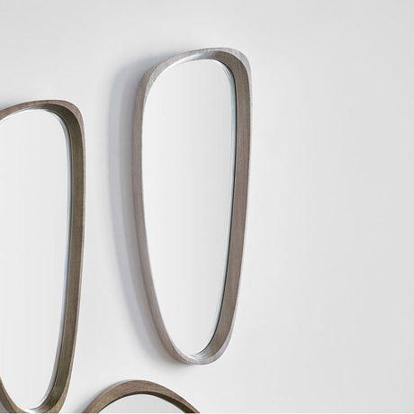 Grey oak wood veneer teardrop-shaped wall mirror, 33 x 90cm, narrow curved frame widening at the base, mounted on a plain white wall.