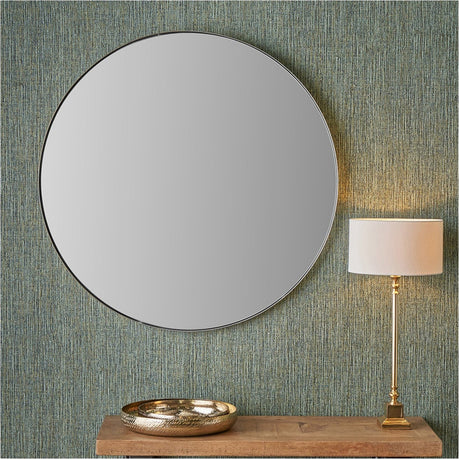 Round wall mirror with a slim brushed silver metal frame, 100 x 100cm, hung above a wooden console table with a brass bowl and table lamp.