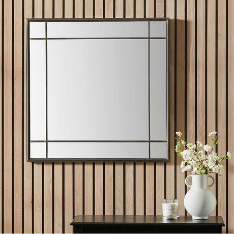 Antique Bronze Square Wall Mirror, 80 x 80cm, with a metal frame divided into panels, hung on a wooden slatted wall above a console table with a vase.