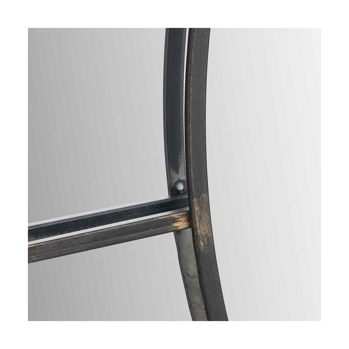 Close-up of the Antique Bronze Round Wall Mirror, 80 x 80cm, showing the curved metal frame edge and crossbar detail against a plain light grey background.
