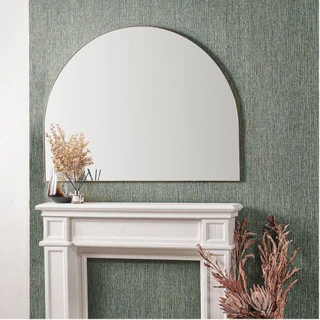 Wide arch wall mirror with slim brushed gold frame, 120 x 90cm, mounted above a white mantelpiece against green textured wallpaper.