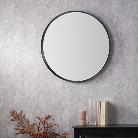 Round wall mirror with a deep black wood veneer frame, 74 x 74cm, hung on a textured grey wall above a black console table with decor.