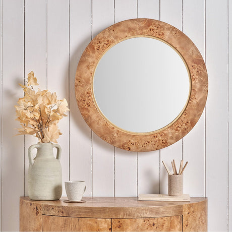 Newborough Burr Effect Round Wall Mirror, 65 x 65cm, with a burr wood-effect frame, shown above a matching wood console table in a hallway setting.