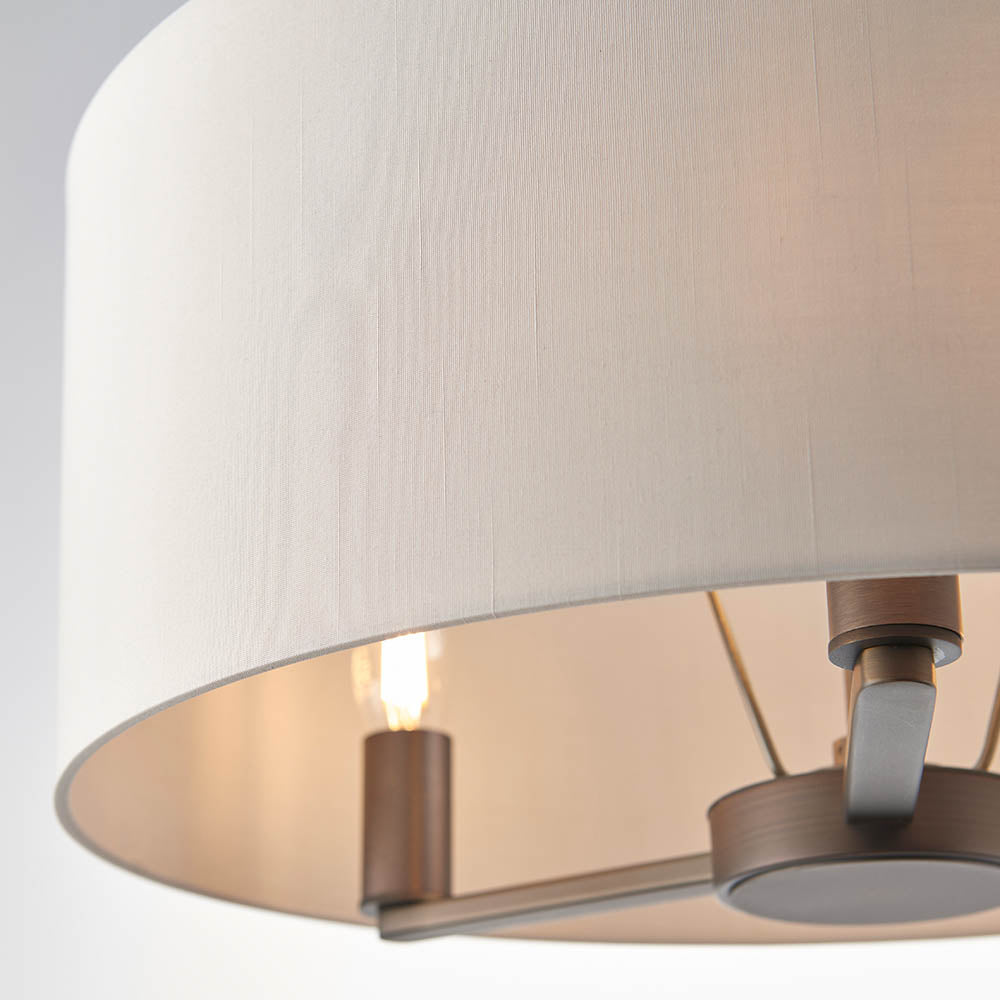 Close-up of the Endon Bexley 3 light pendant showing the marble-effect faux silk shade interior with dark antique bronze fittings and an E14 lamp.