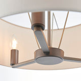 Close-up of Endon Bexley Large 3 Light Pendant showing antique bronze centre plate, arms and one lit E14 candle bulb beneath the marble-effect shade.